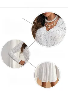 Detailed view of the intricate V-neckline and hollow lace embroidery on the white mini dress