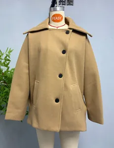 Close-up of camel wool blend coat featuring large lapels and black single-breasted buttons
