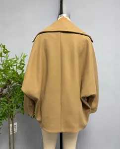 Detail view of camel wool jacket featuring a loose batwing sleeve and oversized silhouette