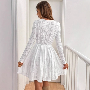 Elegant white lace mini dress with long sleeves and hollow-out scallop trim details