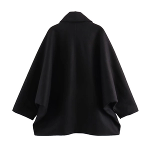 Rear view of a black wool blend minimalist cape jacket with elegant draping and seam detail