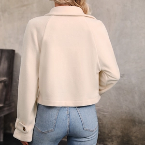 Back view of a casual cream short fleece jacket with a lapel collar and blue jeans