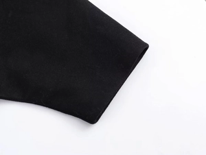 Close-up of premium black wool jacket cuff showing thick felt texture and detailed fabric
