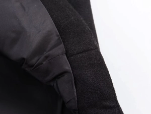 Macro view showing the contrast between grainy wool texture and smooth inner lining