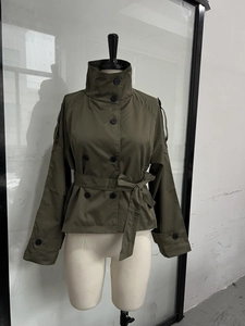 Detailed front view of olive green short trench coat featuring double-breasted buttons