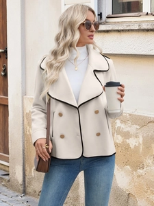 Detailed view of beige cropped wool coat featuring contrast black piping and double-breasted buttons
