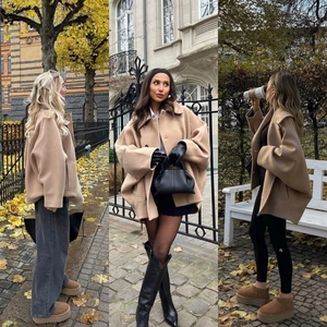 Detailaufnahme des beige Oversize-Wollmantels mit großem Revers und Strukturstoff