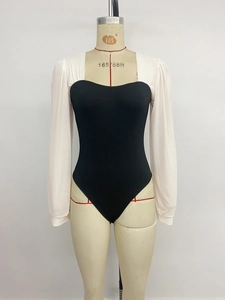 Detailed view of knitted bodycon bodysuit with square neckline and white puff sleeves