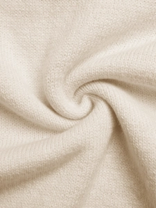 Gros plan sur la maille jacquard crème douce montrant la texture de la laine
