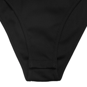 Detail of black ribbed knit fabric with reinforced double-stitch edging on the garment