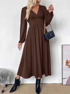 Detailed view of dark brown V-neck long sleeve maxi dress with elastic waist and boots