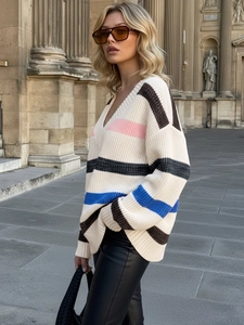 Oversized V-neck knit sweater with multi-color stripes in a stylish street fashion look