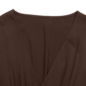 Detail of the deep V-neckline and fine stitching on a brown long sleeve dress