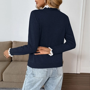 Navy long sleeve knit sweater with white lace trim on collar and cuffs, back view