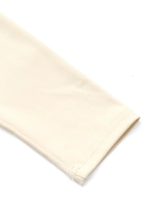 Close-up of cream white ribbed knit fabric texture and high-quality hemmed cuff stitching