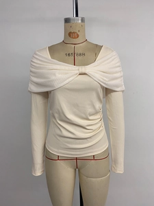 Detail of off-white knit top with mesh bowknot shoulder and ruching texture
