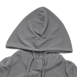 Detail of grey ribbed knit jumpsuit showing hooded neckline and matching drawstrings