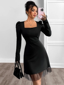 Detail showing high-waist mesh patchwork hem on this black square neck puff sleeve dress