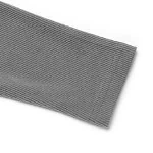 Macro view of ribbed knit cuffs and fine stitching on dark grey long sleeve jumpsuit