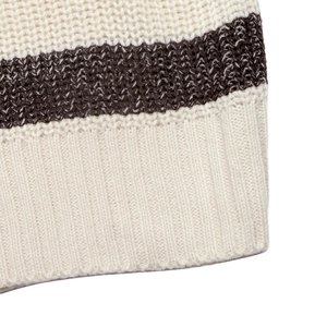 Macro view of cream and dark brown striped knit fabric with ribbing and soft texture