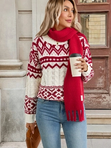 Detailed close-up of retro red and white knit sweater with geometric wavy pattern