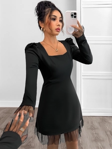 Detail of square neck and mesh sleeves on this elegant black high-waist A-line dress