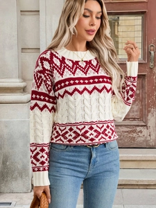 Detailed view of red and white Christmas sweater with cable knit and snowflake pattern