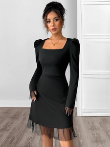 Detail of square neck and mesh puff sleeves on this elegant black high waist A-line dress