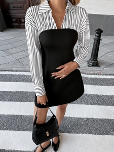 Detail of elegant two-piece style dress with striped shirt collar and slim black skirt