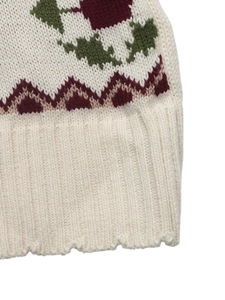 Close-up of thick knit sweater hem with colorful floral jacquard pattern and ribbed cuffs