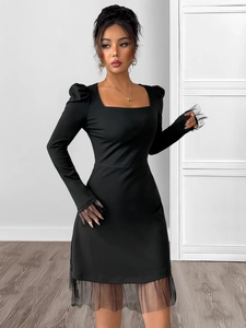 Detail of square neck and mesh patchwork puff sleeves on a slim black dress