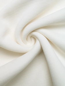 Close-up of white knitted sweatshirt fabric showing soft texture and high-density fiber detail
