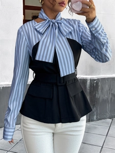 Detail of elegant striped patchwork shirt top with oversized bow tie and waist belt