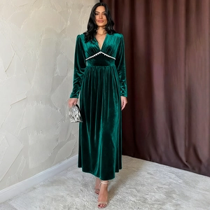 Detail of the deep emerald velvet dress showing the V-neckline and exquisite lace trim