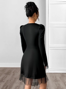 Detail of puffed sleeves and black translucent mesh ruffles on the back of the dress