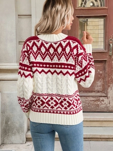 Detail view of red and white vintage geometric knit pattern on festive sweater back