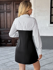 Detail of elegant two-piece style dress with striped shirt collar and black slim skirt