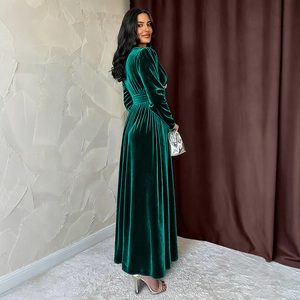 Elegant emerald green V-neck velvet dress with long sleeves and pleated waist details