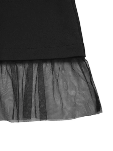 Detail view of the black dress hem featuring layered tulle mesh and ruffled stitching