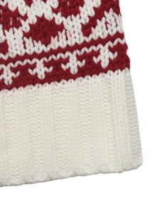 Detailed macro view of festive red and white jacquard knit with ribbed cuff finish