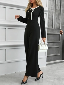 Detail of the contrast collar and golden double-breasted buttons on a black jumpsuit