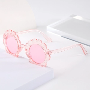 Pink shell-shaped glitter sunglasses for kids with round lenses and sparkly frames