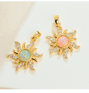 Detail view of gold sun pendants with opal center stones and sparkling zircon rays