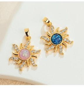 Detail of sun star pendants with pink opal, blue stone and zircon inlay in gold plating