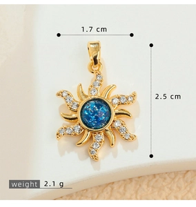 Macro detail of gold sunburst pendant with blue stone and size measurements