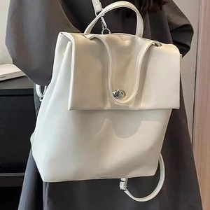 Detail of off-white leather backpack with silver turn-lock and adjustable straps