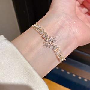 Close-up of 18k gold plated bracelet with marquise cut zircons in floral leaf design