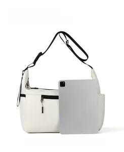 Confronto dimensioni di una borsa a tracolla in nylon bianco con un tablet grigio interno