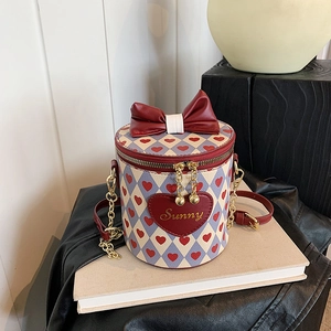 Blue and white checkered bucket bag with red heart pattern and large leather bow