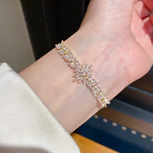 Close-up of 18k gold plated flower bracelet with marquise zircon leaves on wrist